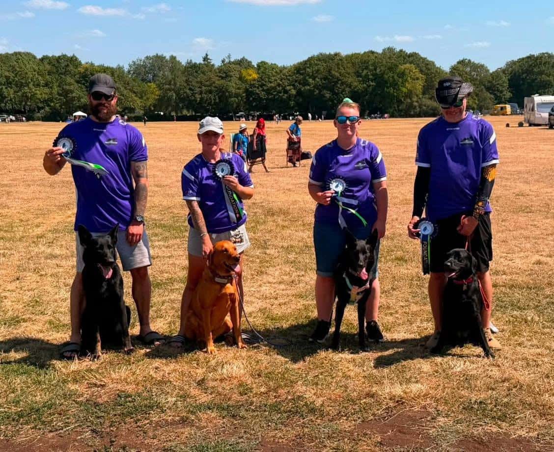 The Dartmoor Dreamers team with their dogs and rosettes